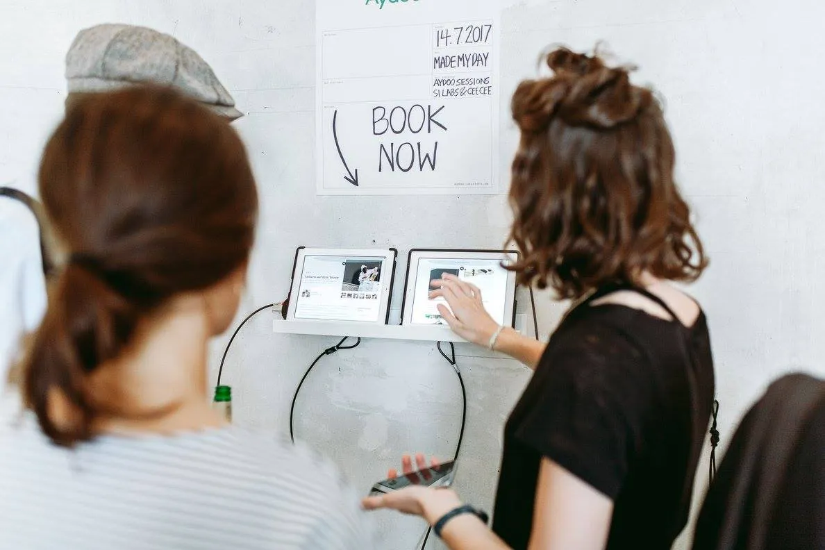 Impressions from opening party; Women trying the website on an iPad.
